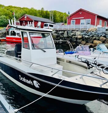 The “Seahawk,” a lodge-owned fishing boat, is moored and ready in the harbor, offering guests a comfortable and reliable vessel for guided fishing trips along the Norwegian coast.