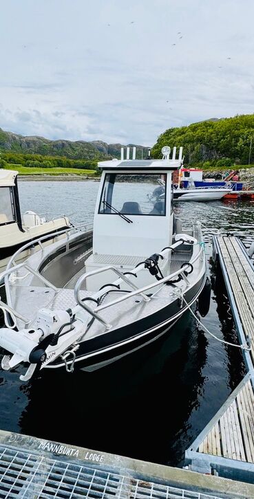 Boats are safely moored in the sheltered home harbor of Steinvik near Oksvoll. Surrounded by calm waters and green coastal scenery, this is the starting point for unforgettable fishing trips and maritime experiences in Norway.