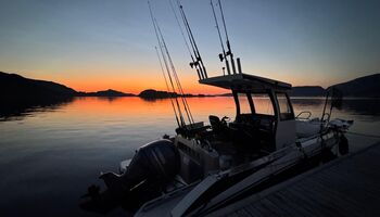 Die untergehende Sonne taucht den Hafen von Bessaker in warme Farben, während die „Seahawk“ ruhig am Steg liegt. Das sanfte Licht spiegelt sich im Wasser und schafft eine besondere Atmosphäre – ein perfekter Moment zum Innehalten nach einem erlebnisreiche
